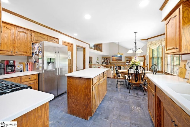 3 Staten Ln, Taylors, SC 29687 - kitchen with stainless steel fridge, a center island, light countertops, ornamental molding, and pendant lighting