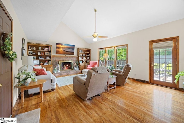 3 Staten Ln, Taylors, SC 29687 - living area with light wood-style flooring, ceiling fan, a fireplace, high vaulted ceiling, and baseboards