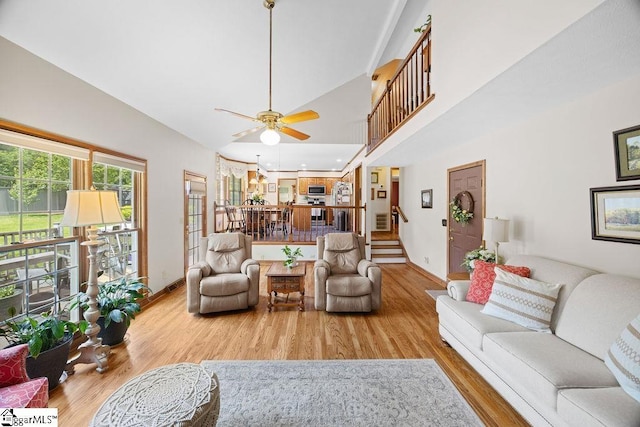 3 Staten Ln, Taylors, SC 29687 - living area with wood finished floors, stairway, ceiling fan, baseboards, and high vaulted ceiling
