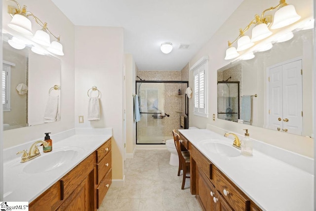 3 Staten Ln, Taylors, SC 29687 - bathroom with two vanities, a stall shower, toilet, and tile patterned floors