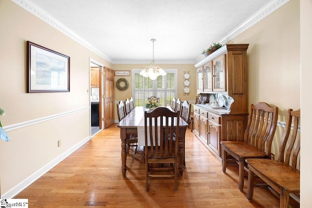3 Staten Ln, Taylors, SC 29687 - dining space with a chandelier, light wood finished floors, crown molding, and baseboards