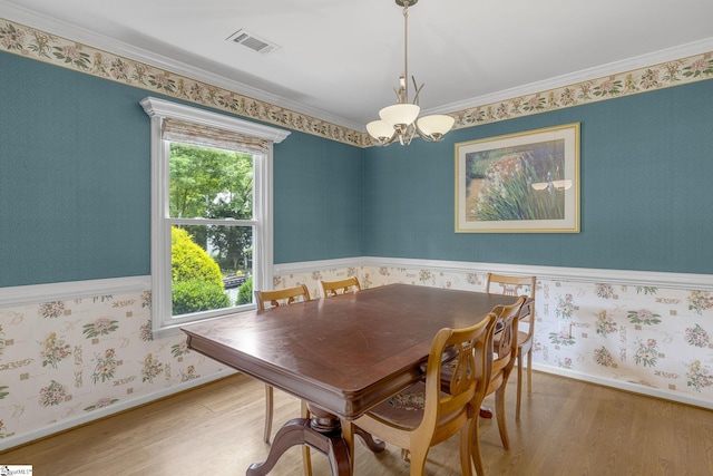 411 Wild Horse Creek Dr, Simpsonville, SC 29680 - dining space with a chandelier, wood finished floors, wallpapered walls, baseboards, and ornamental molding