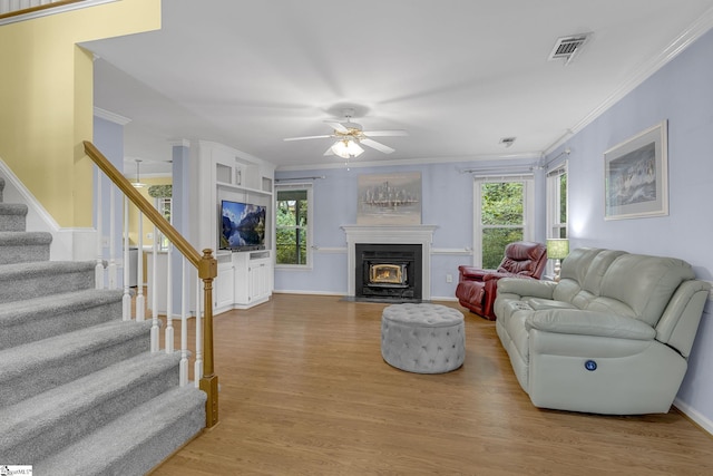 411 Wild Horse Creek Dr, Simpsonville, SC 29680 - living area featuring wood finished floors, crown molding, stairs, a ceiling fan, and a fireplace with flush hearth