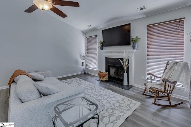 349 Hamilton Pkwy, Easley, SC 29642 - living area featuring wood finished floors, a fireplace with raised hearth, a ceiling fan, baseboards, and vaulted ceiling