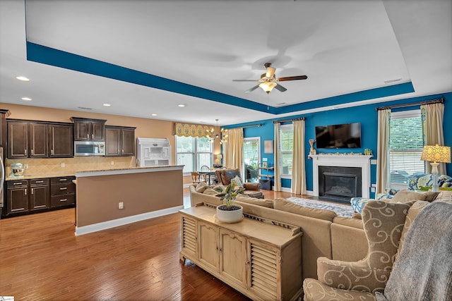 201 Wiscasset Way, Greenville, SC 29615 - living room featuring a ceiling fan, a raised ceiling, wood finished floors, plenty of natural light, and recessed lighting
