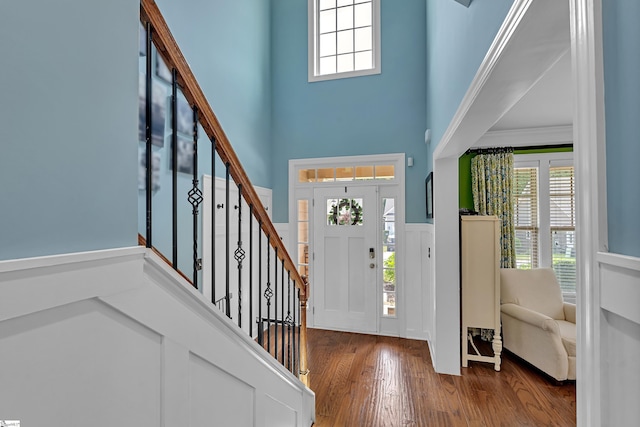 201 Wiscasset Way, Greenville, SC 29615 - foyer featuring a towering ceiling, stairway, wainscoting, wood finished floors, and plenty of natural light