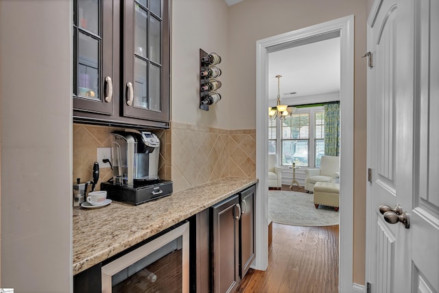 201 Wiscasset Way, Greenville, SC 29615 - bar area with beverage cooler, wood finished floors, backsplash, and a chandelier