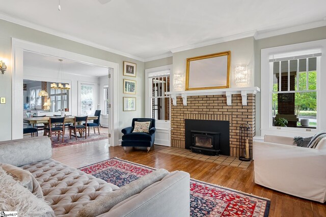 227 S Main St, Anderson, SC 29654 - living room featuring crown molding, wood finished floors, and a chandelier