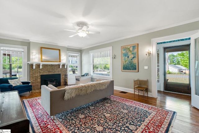 227 S Main St, Anderson, SC 29654 - living area featuring a ceiling fan, ornamental molding, a brick fireplace, wood finished floors, and baseboards