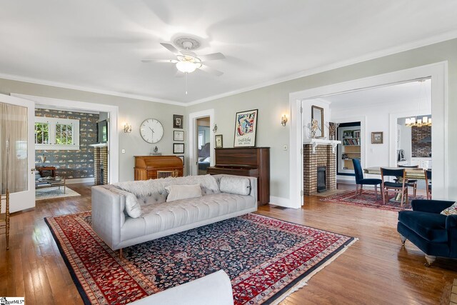 227 S Main St, Anderson, SC 29654 - living area with ceiling fan, a chandelier, wood finished floors, crown molding, and baseboards