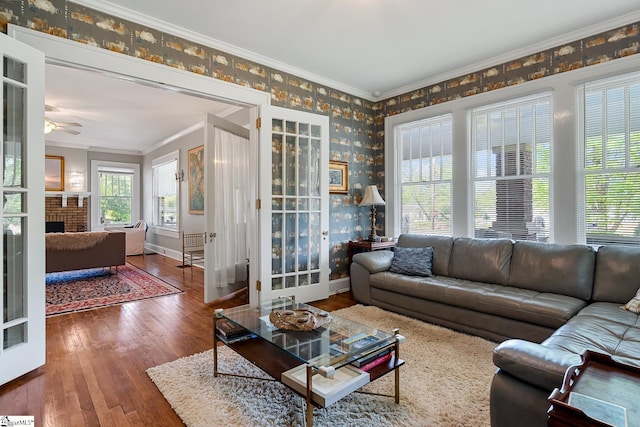 227 S Main St, Anderson, SC 29654 - living room with wallpapered walls, crown molding, hardwood / wood-style floors, ceiling fan, and baseboards