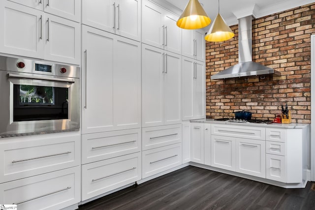 227 S Main St, Anderson, SC 29654 - kitchen featuring oven, wall chimney exhaust hood, gas stovetop, light countertops, and white cabinets