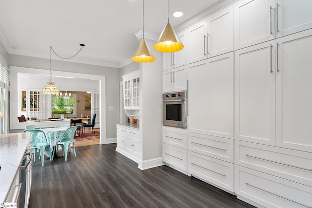 227 S Main St, Anderson, SC 29654 - kitchen with crown molding, oven, light stone counters, dark wood-style flooring, and white cabinets