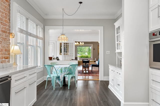 227 S Main St, Anderson, SC 29654 - dining area featuring dark wood-style flooring, a chandelier, crown molding, and baseboards