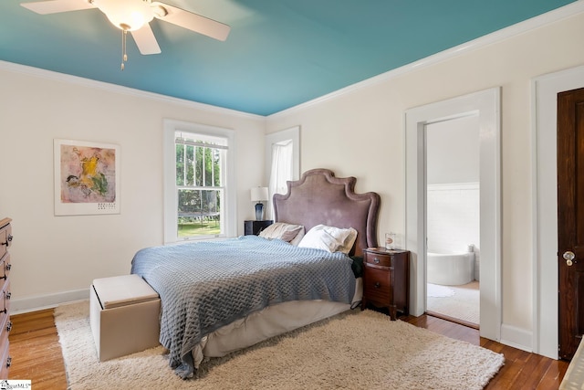 227 S Main St, Anderson, SC 29654 - bedroom featuring crown molding, wood finished floors, baseboards, ensuite bath, and ceiling fan