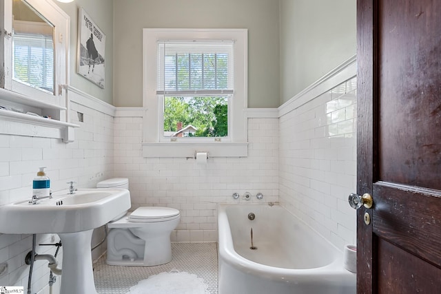 227 S Main St, Anderson, SC 29654 - full bath featuring a bath, toilet, tile patterned floors, healthy amount of natural light, and tile walls