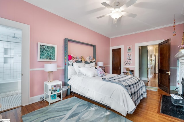 227 S Main St, Anderson, SC 29654 - bedroom featuring wood finished floors, ornamental molding, baseboards, connected bathroom, and ceiling fan