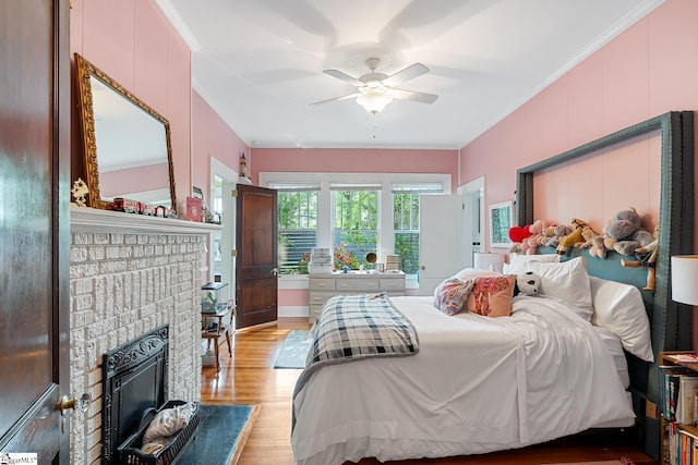 227 S Main St, Anderson, SC 29654 - bedroom featuring ornamental molding, light wood finished floors, a fireplace, and a ceiling fan