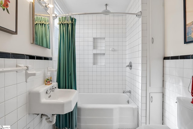 227 S Main St, Anderson, SC 29654 - bathroom featuring tile walls, shower / tub combo with curtain, toilet, and wainscoting
