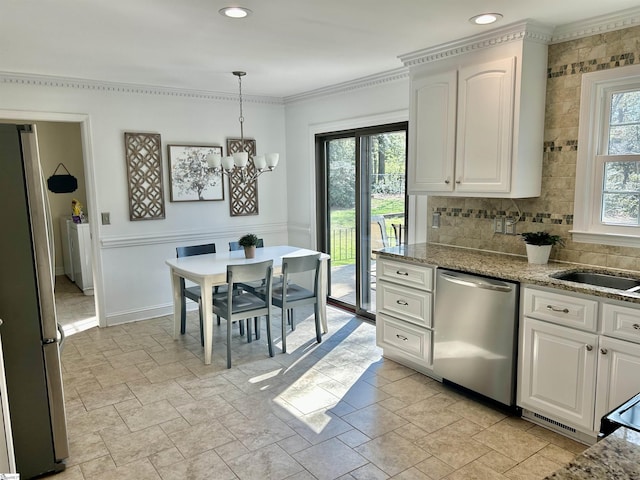 207 White Water Ct, Greer, SC 29650 - kitchen featuring appliances with stainless steel finishes, stone tile flooring, a chandelier, ornamental molding, and white cabinetry