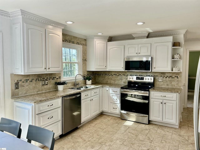 207 White Water Ct, Greer, SC 29650 - kitchen featuring stainless steel appliances, a sink, decorative backsplash, open shelves, and ornamental molding