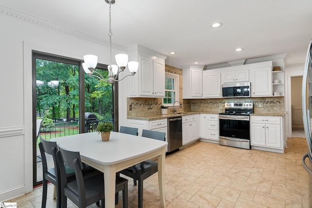 207 White Water Ct, Greer, SC 29650 - kitchen with appliances with stainless steel finishes, a sink, backsplash, a chandelier, and white cabinetry