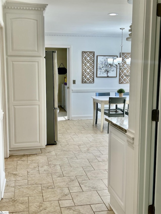 207 White Water Ct, Greer, SC 29650 - kitchen featuring freestanding refrigerator, decorative light fixtures, light stone counters, and a chandelier