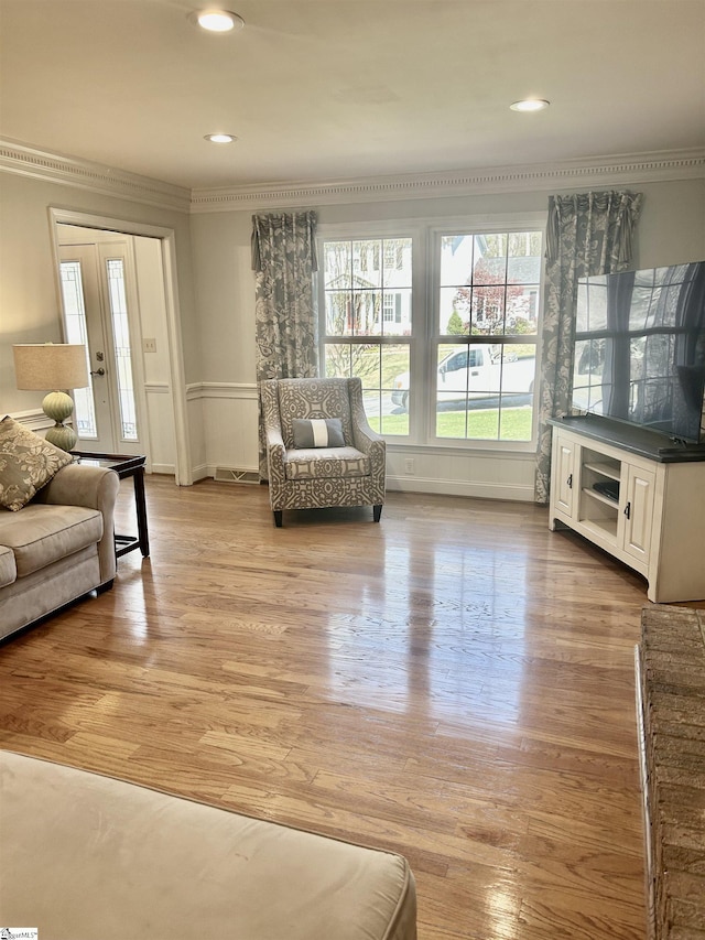 207 White Water Ct, Greer, SC 29650 - living room featuring ornamental molding, light wood-style flooring, recessed lighting, and a wainscoted wall