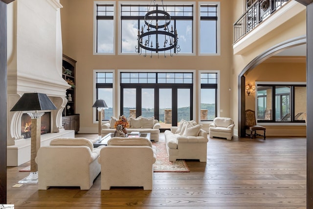 58 Wild Ginger Rd, Landrum, SC 29356 - living area with arched walkways, healthy amount of natural light, hardwood / wood-style flooring, and a towering ceiling