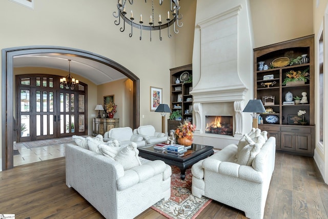 58 Wild Ginger Rd, Landrum, SC 29356 - living area with a chandelier, arched walkways, wood finished floors, and a fireplace