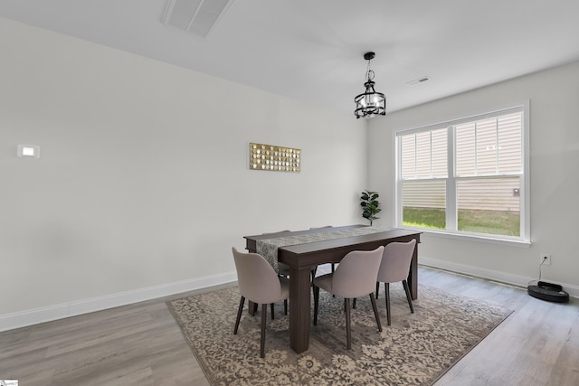 115 River Trace Loop, Simpsonville, SC 29680 - dining space featuring wood finished floors, baseboards, and a chandelier