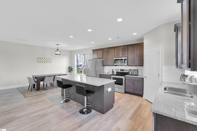 115 River Trace Loop, Simpsonville, SC 29680 - kitchen featuring stainless steel appliances, a sink, decorative backsplash, a center island, and a breakfast bar