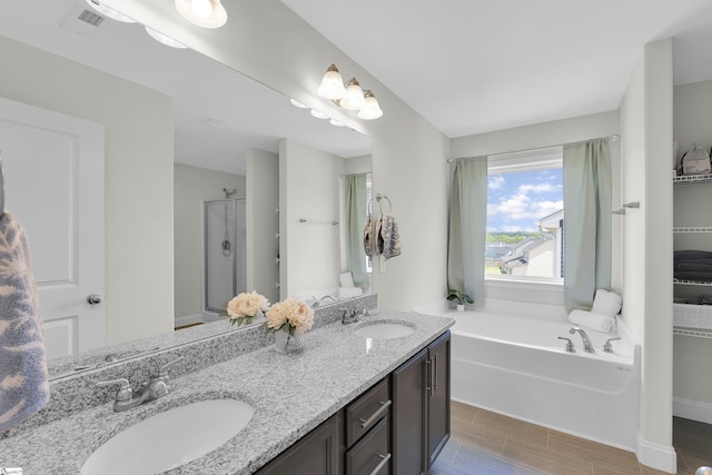 115 River Trace Loop, Simpsonville, SC 29680 - bathroom with double vanity, a garden tub, and wood tiled floors
