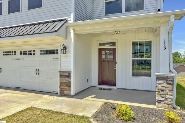 115 River Trace Loop, Simpsonville, SC 29680 - view of exterior entry with a garage, a porch, stone siding, and metal roof