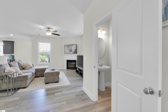 115 River Trace Loop, Simpsonville, SC 29680 - living room featuring baseboards, a ceiling fan, a glass covered fireplace, light wood-style floors, and recessed lighting