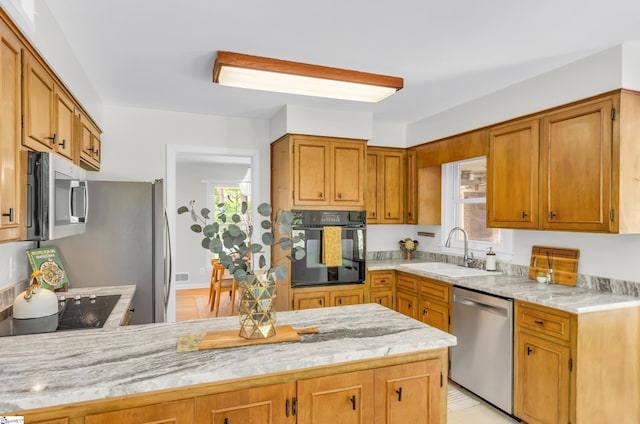 116 Arnold Dr, Anderson, SC 29621 - kitchen featuring black appliances, a sink, plenty of natural light, and a peninsula