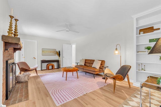 116 Arnold Dr, Anderson, SC 29621 - living room with built in shelves, light wood finished floors, baseboards, a brick fireplace, and ceiling fan