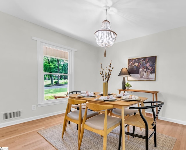 116 Arnold Dr, Anderson, SC 29621 - dining space featuring a chandelier, light wood-style floors, and baseboards