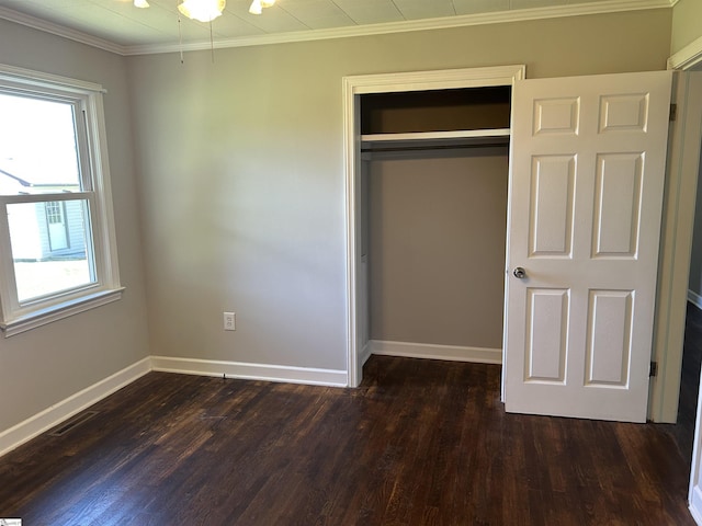325 Byrnes St, Joanna, SC 29351 - unfurnished bedroom with multiple windows, a closet, dark wood-type flooring, and crown molding