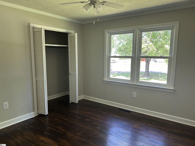 325 Byrnes St, Joanna, SC 29351 - unfurnished bedroom with crown molding, dark wood finished floors, baseboards, and a closet