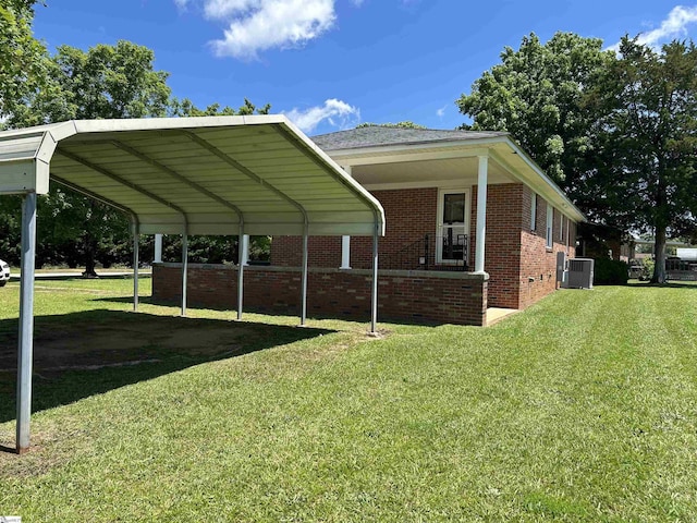325 Byrnes St, Joanna, SC 29351 - view of side of home featuring central AC unit, brick siding, a lawn, and a detached carport