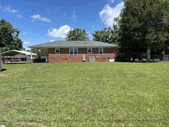 325 Byrnes St, Joanna, SC 29351 - back of house with crawl space, a lawn, a carport, and brick siding