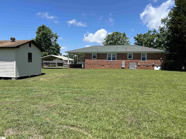325 Byrnes St, Joanna, SC 29351 - rear view of property with a carport, a yard, brick siding, and crawl space