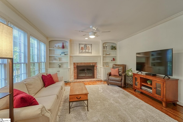 201 Woodridge Dr, Spartanburg, SC 29301 - living area featuring ornamental molding, wood finished floors, a brick fireplace, ceiling fan, and built in shelves