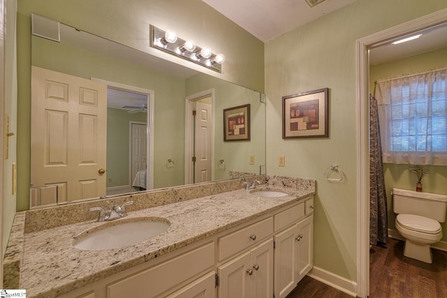 201 Woodridge Dr, Spartanburg, SC 29301 - full bath featuring wood finished floors, toilet, double vanity, and baseboards