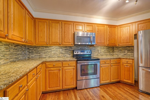 201 Woodridge Dr, Spartanburg, SC 29301 - kitchen with stainless steel appliances, light stone countertops, wood finished floors, brown cabinets, and crown molding