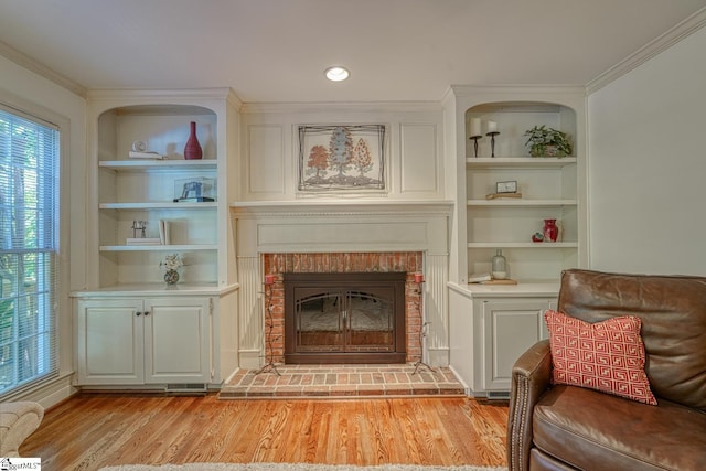 201 Woodridge Dr, Spartanburg, SC 29301 - living area with light wood-style flooring, built in features, a brick fireplace, and crown molding
