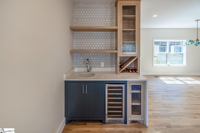 11 Stall St, Greenville, SC 29609 - indoor wet bar featuring beverage cooler, light wood-style flooring, and baseboards
