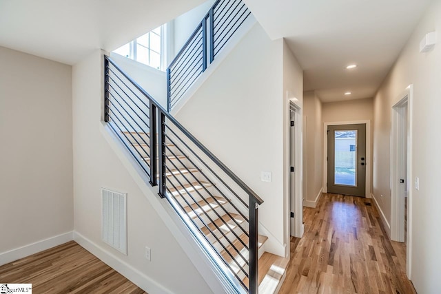 11 Stall St, Greenville, SC 29609 - foyer with plenty of natural light, light wood-style floors, stairway, baseboards, and recessed lighting