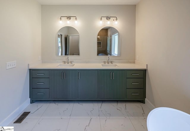 11 Stall St, Greenville, SC 29609 - bathroom with marble look tiles, double vanity, baseboards, and plenty of natural light